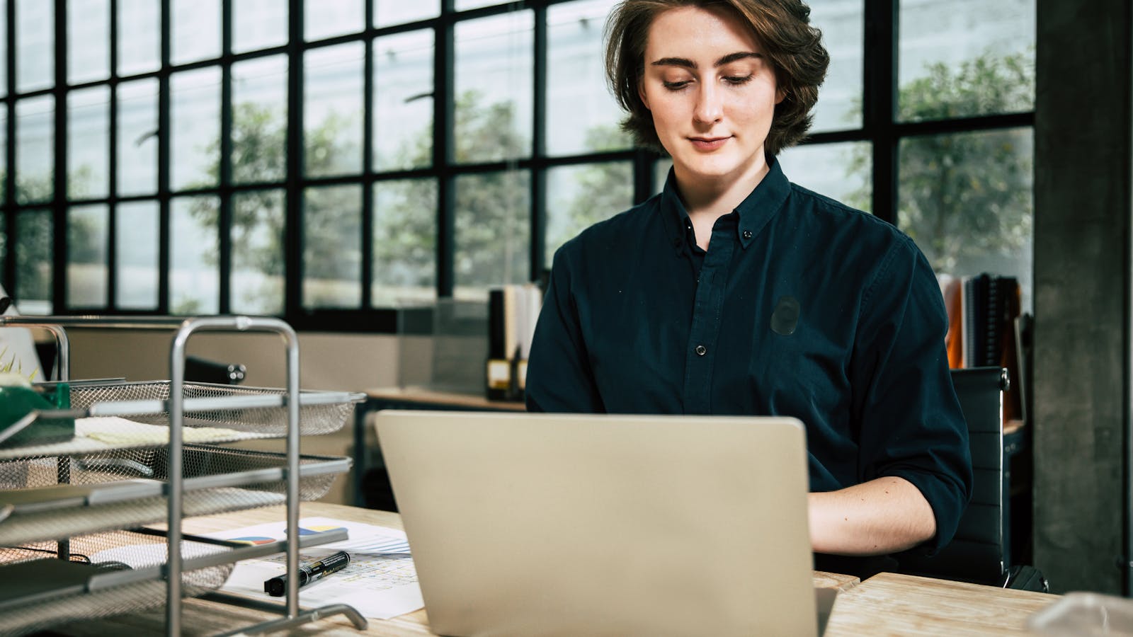 A professional working in a bright modern office setting.