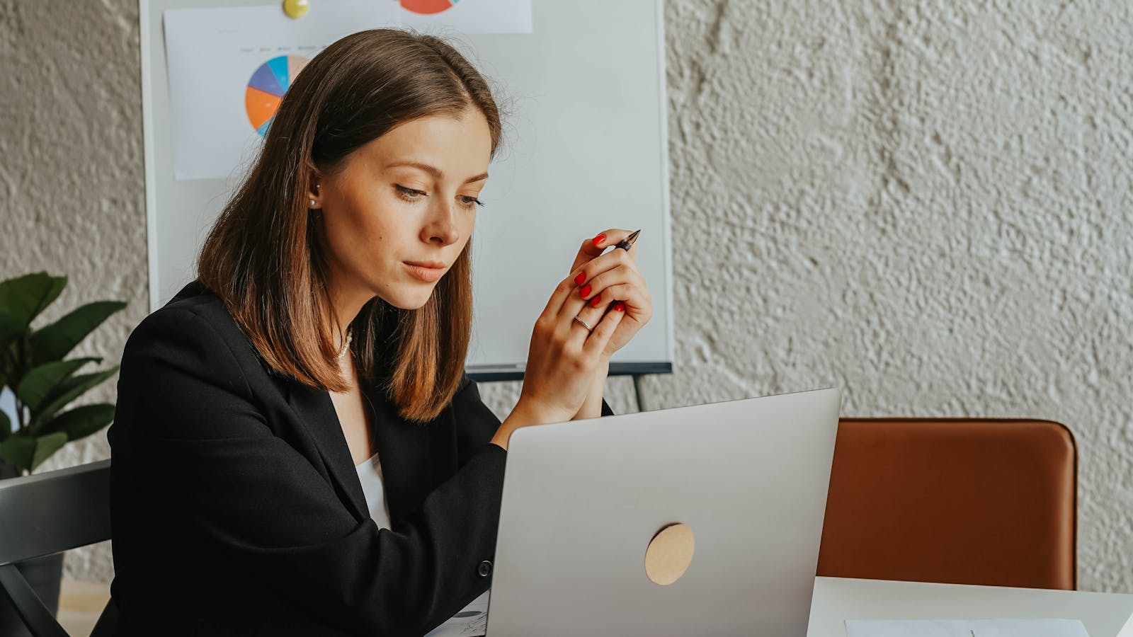 A young professional woman collaborating with colleagues in a meeting room.