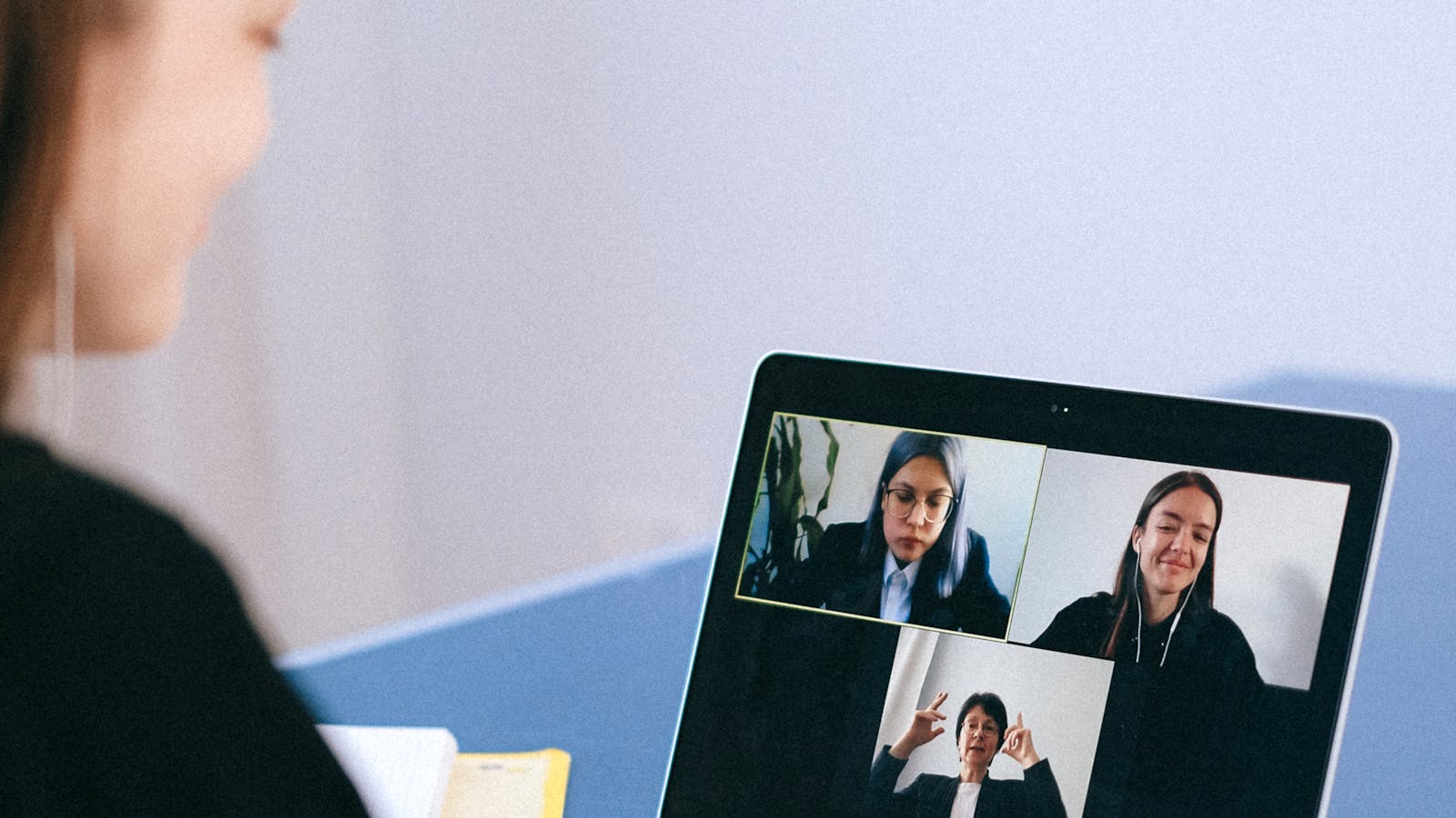 A young professional woman collaborating with colleagues in a meeting room.